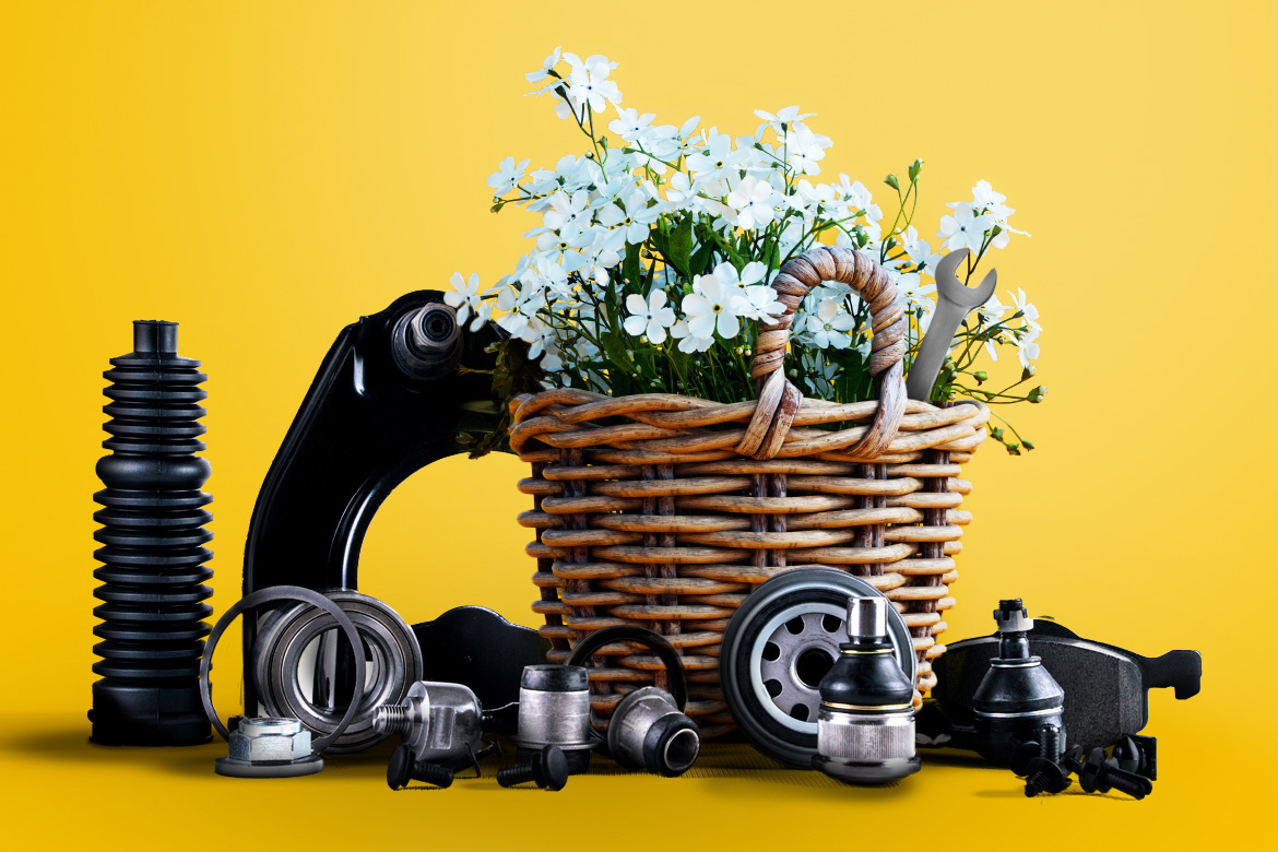 Spring easter basket with flowers and car parts nearby